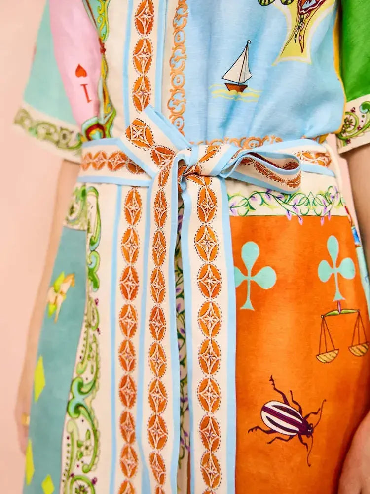 Colorful apron with patterned design on a person wearing it.