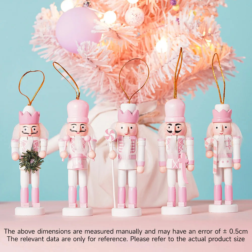 Set of pink nutcracker ornaments with wreaths against a decorative background