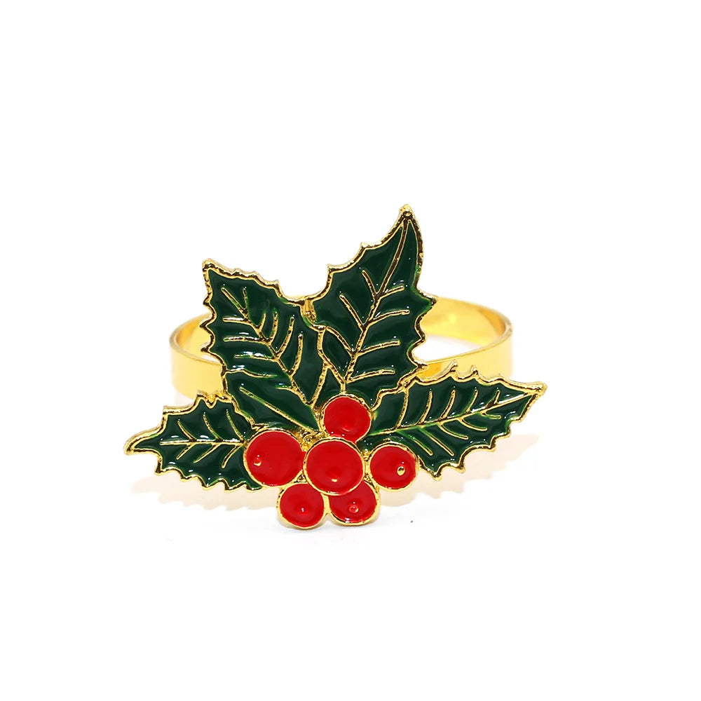 Gold ring with green holly leaves and red berries on a white background