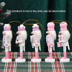 Set of decorative nutcrackers with pink and white attire on a plaid surface.