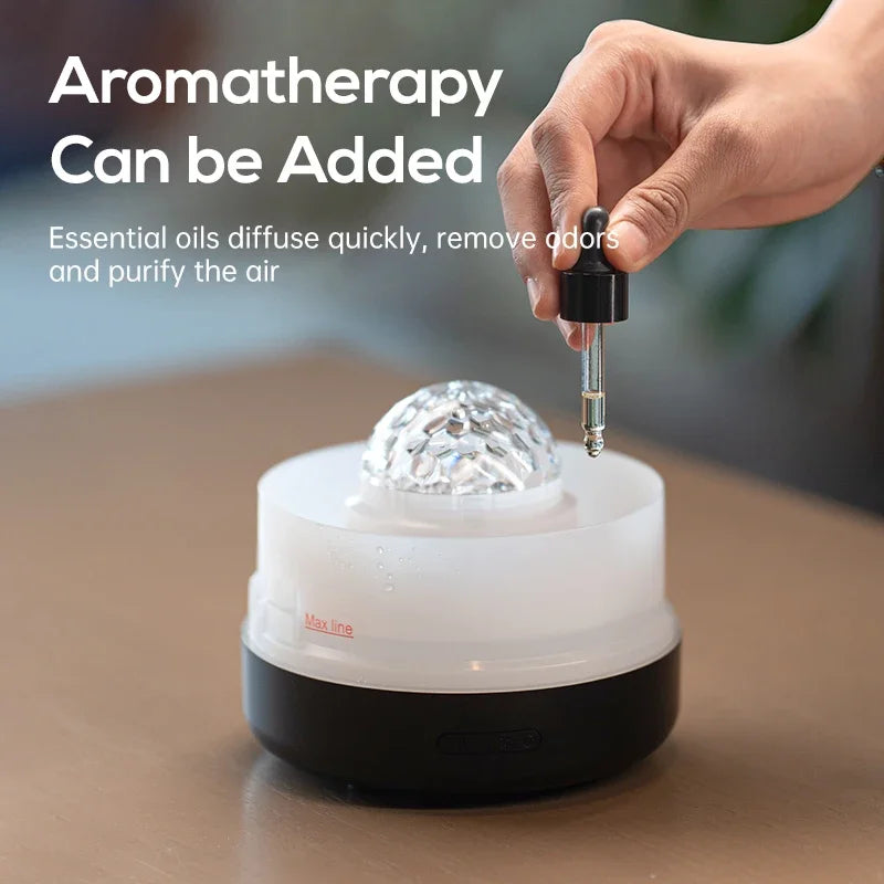 Hand using a dropper to add essential oils into a diffuser with text about aromatherapy.