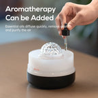 Hand using a dropper to add essential oils into a diffuser with text about aromatherapy.