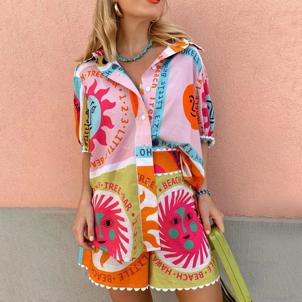 Woman wearing a colorful patterned outfit against a pink wall