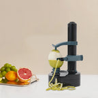 Fruit peeler with a green apple being peeled on a beige background