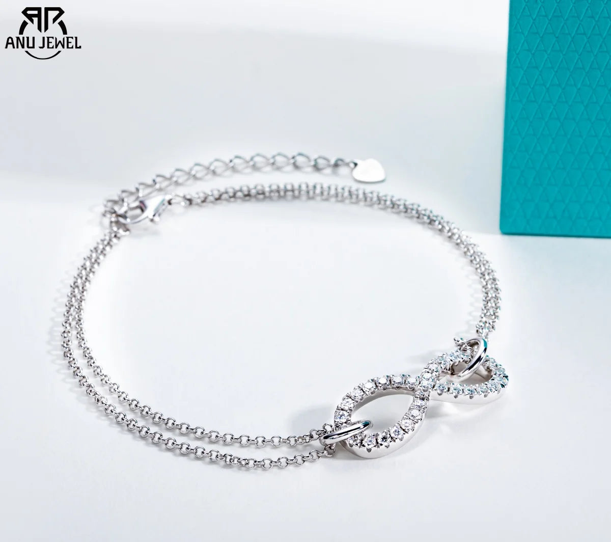 Silver bracelet with heart design on a white background, featuring ANU JEWEL branding.