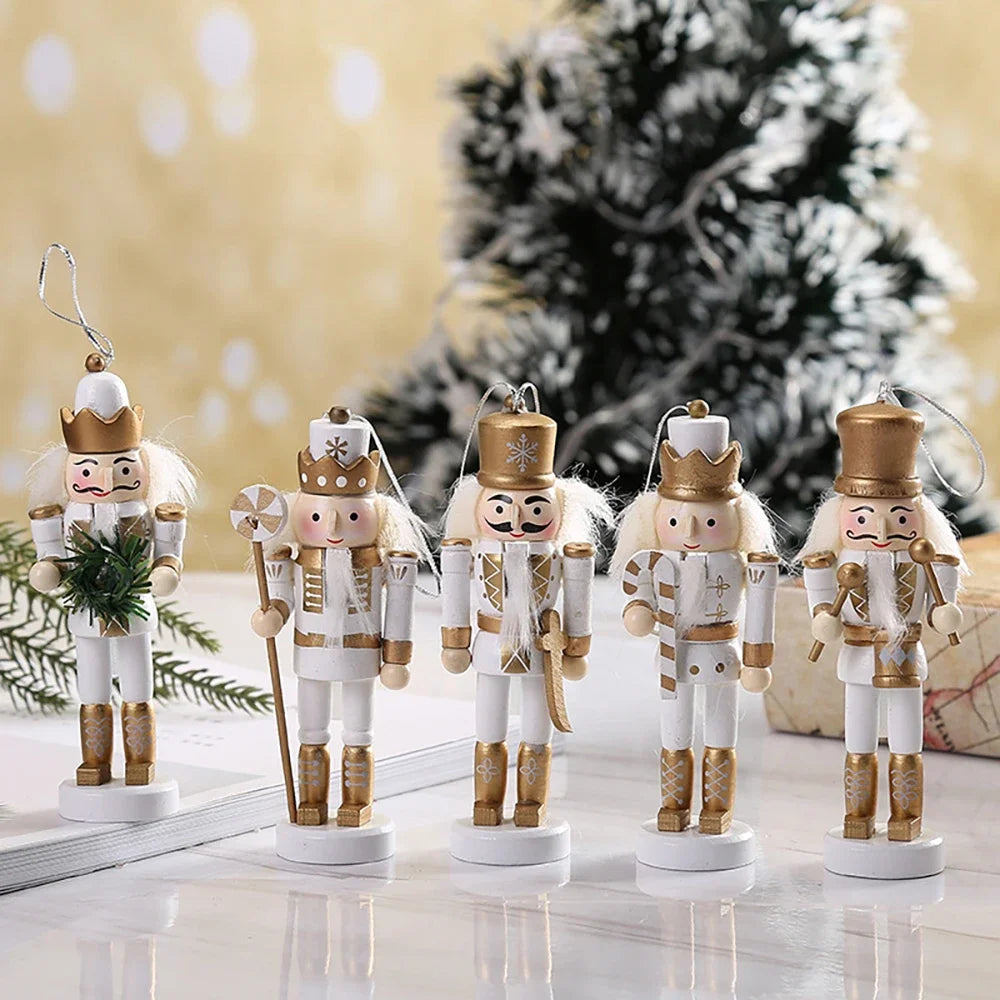 Set of five nutcracker figurines with gold and white attire on a reflective surface with a blurred Christmas tree in the background.