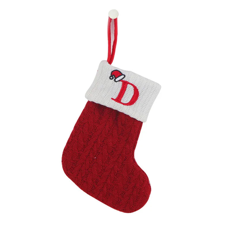 Red knitted Christmas stocking with a white cuff featuring a red letter 'D' on a white background.