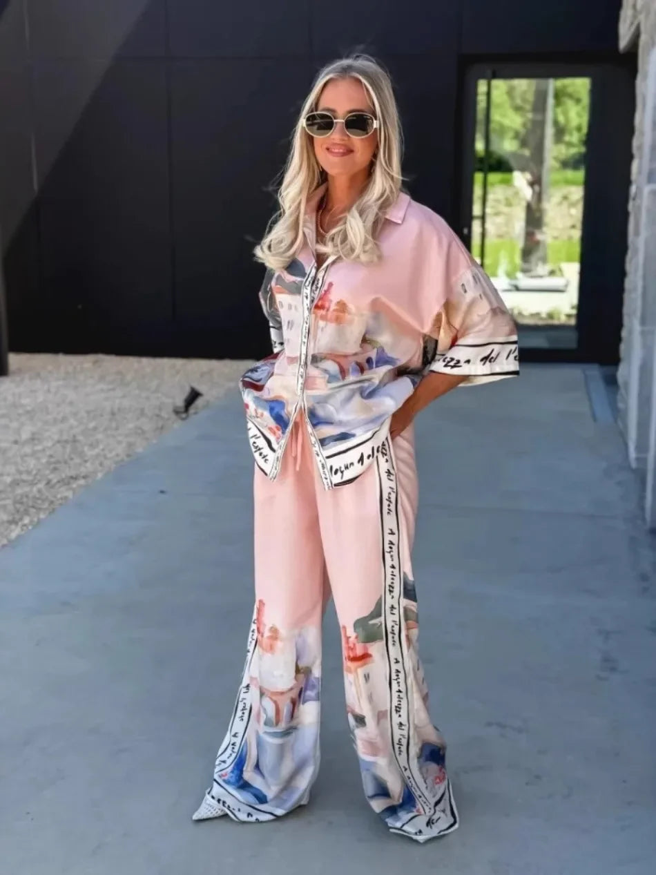 Woman wearing a patterned outfit standing outdoors.