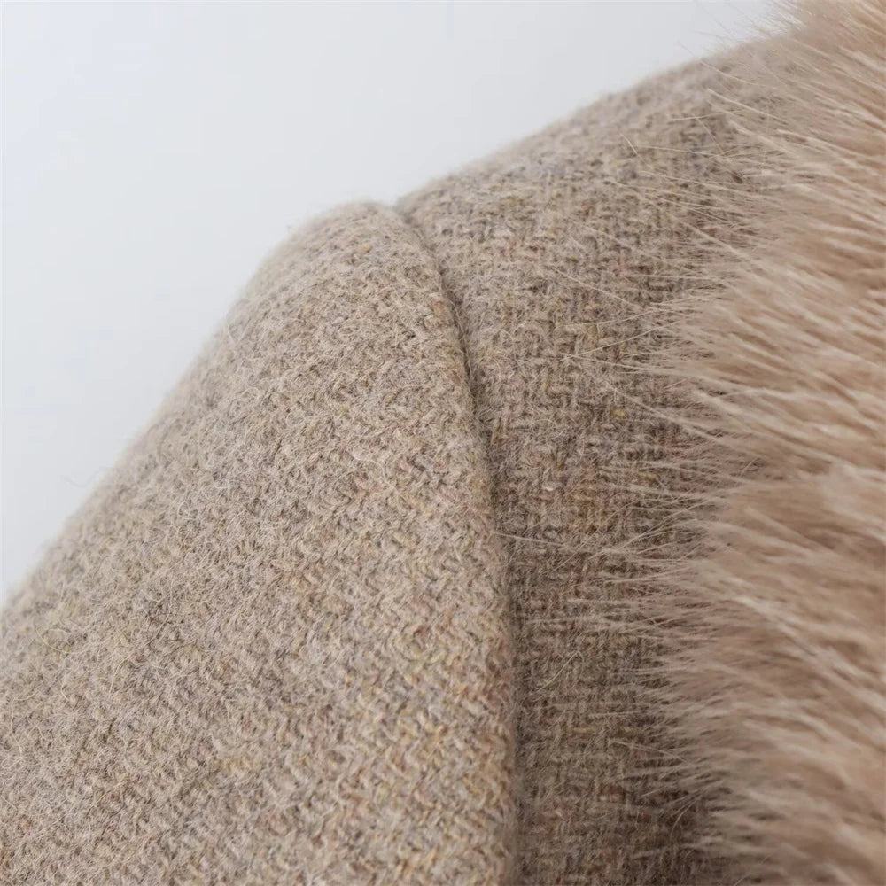 Close-up of a textured fabric with a blend of beige and brown colors on a white background.