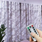 Hand holding a remote control in front of a curtain with LED lights
