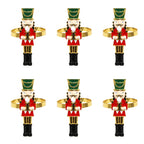 Set of six nutcracker-shaped napkin rings on a white background