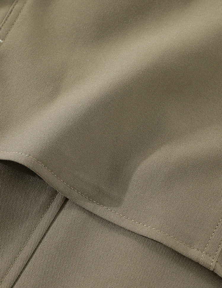 Close-up of beige fabric with a focus on texture and stitching