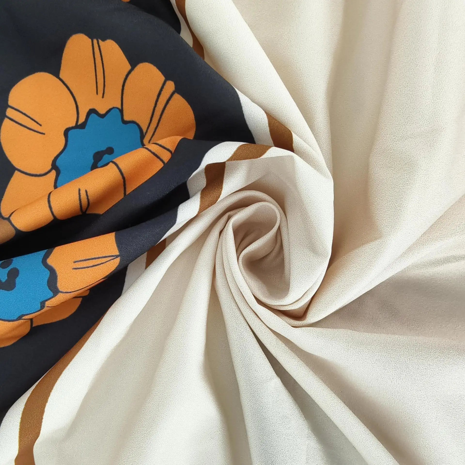 Close-up of fabric with a colorful floral design on a black background