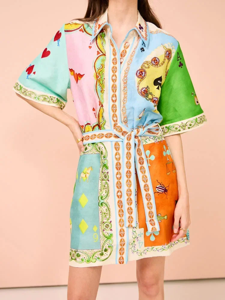 Colorful patterned dress with a belt on a peach background