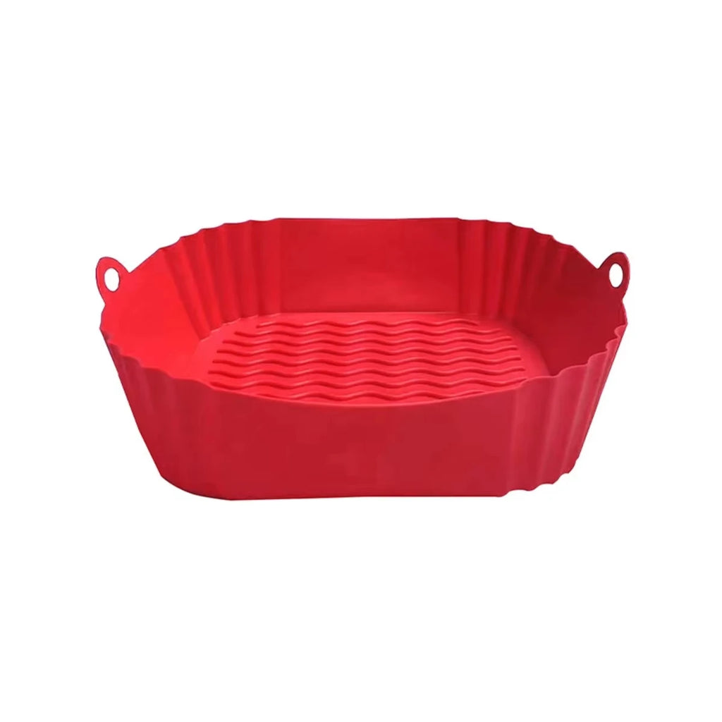 Red silicone baking dish with handles on a white background