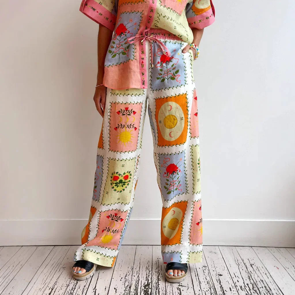 Person wearing a colorful patchwork outfit with a pattern of squares on a plain background