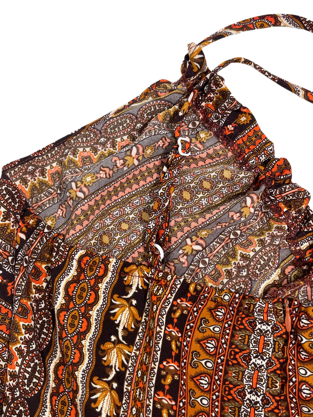 Close-up of a patterned fabric with intricate designs on a white background