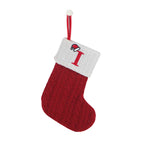 Red Christmas stocking with white cuff featuring a letter 'I' on a white background