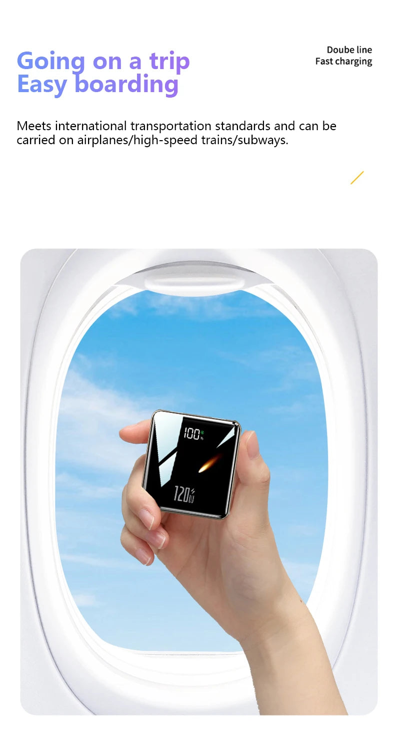 Hand holding a small electronic device with airplane window and blue sky in the background