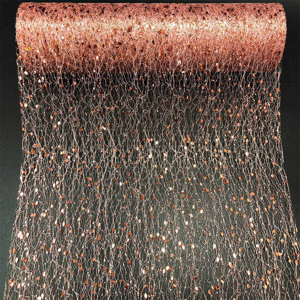 Roll of rose gold glitter mesh on a black background