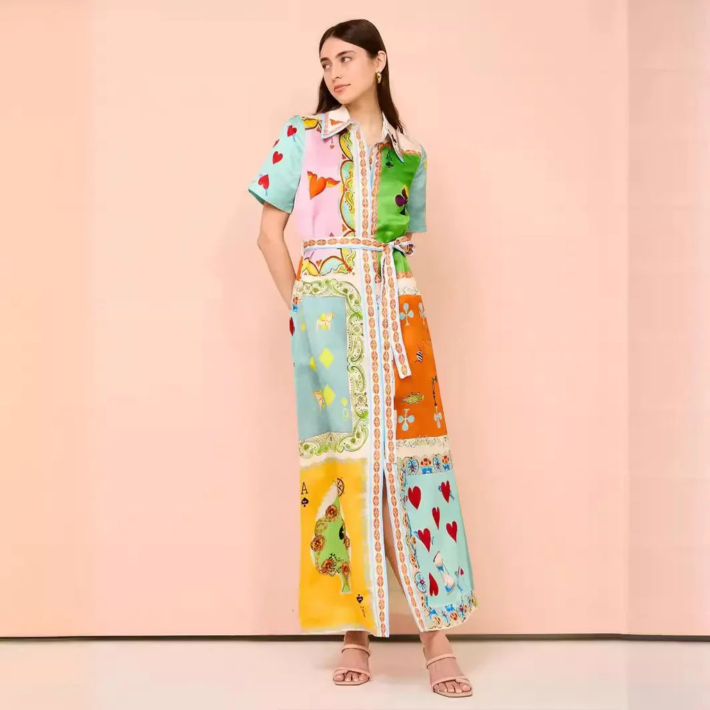 Woman wearing a colorful patterned dress against a pink background