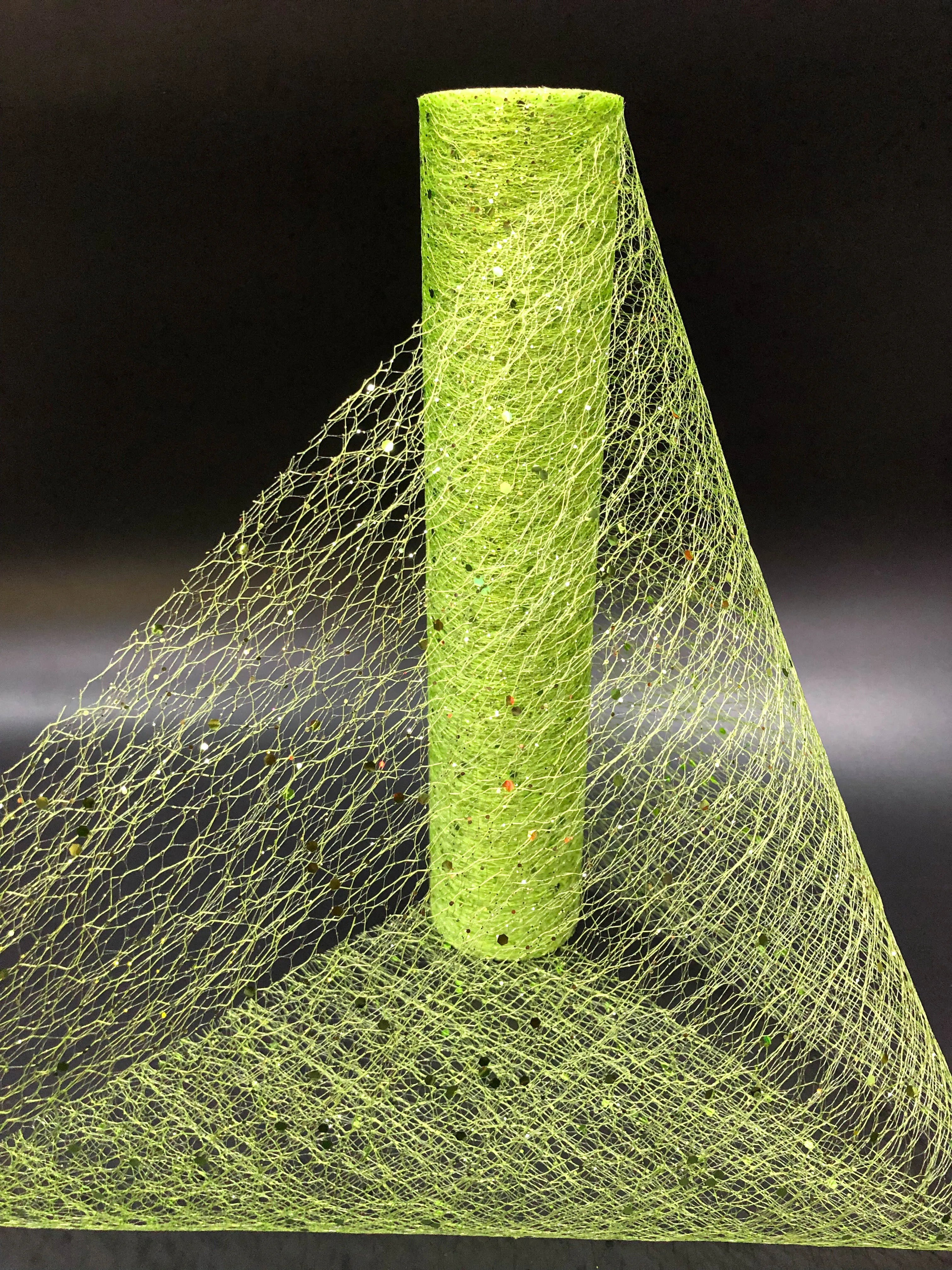 Green mesh fabric with a cylindrical green object on a black background