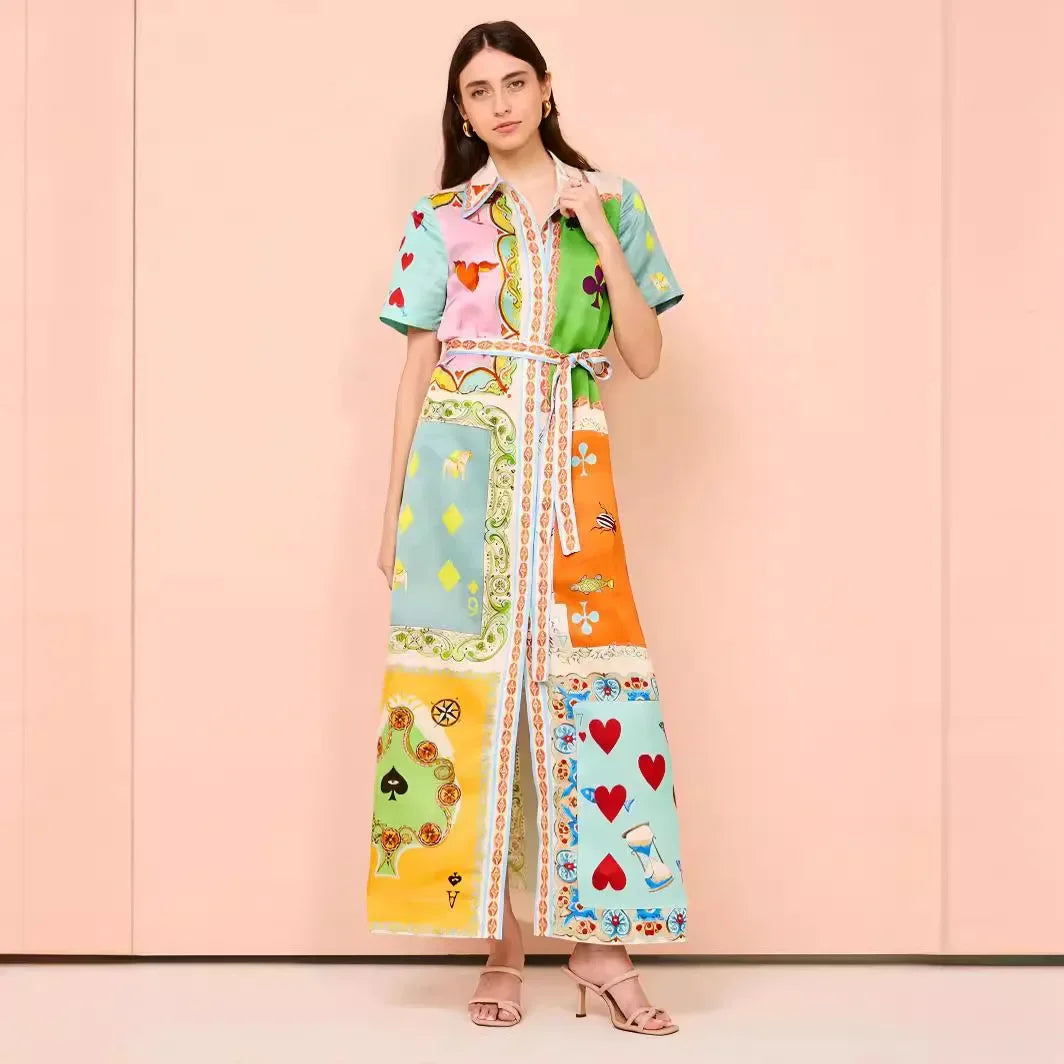 Woman wearing a colorful patterned dress against a pink background