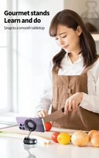 Woman in a kitchen using a smartphone stand with vegetables on the table