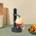Apple peeler on a kitchen counter with a bowl of fruits in the background