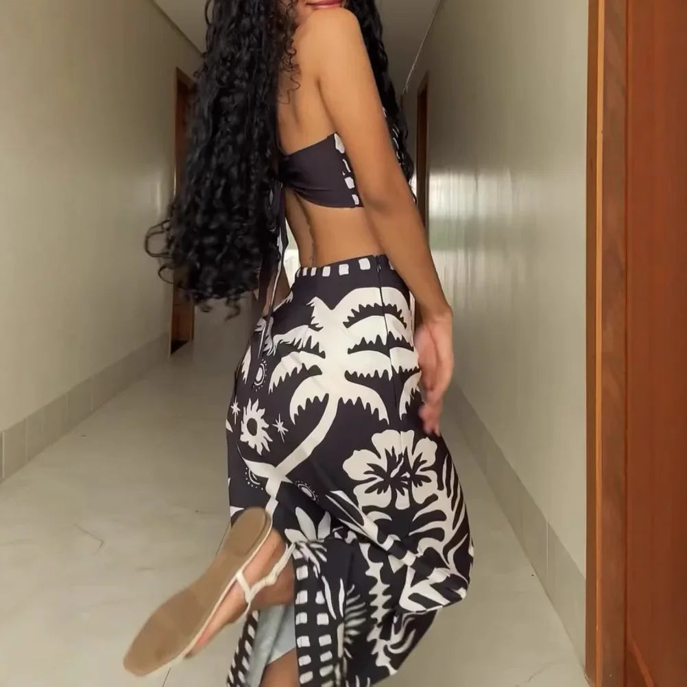 Woman wearing a black and white patterned dress in a hallway