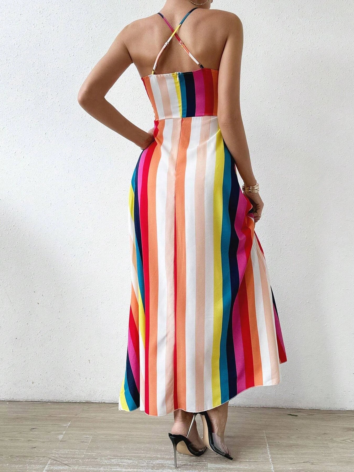 Person wearing a colorful striped dress against a white background