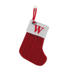 Red knitted Christmas stocking with a white cuff and letter 'W' on a white background