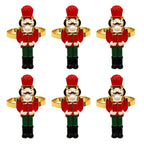 Set of six nutcracker-shaped napkin rings on a white background