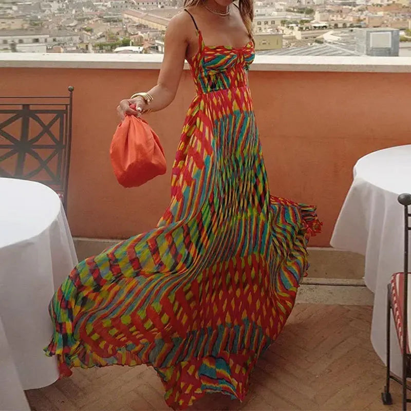 Person wearing a colorful dress on a balcony with tables and chairs.