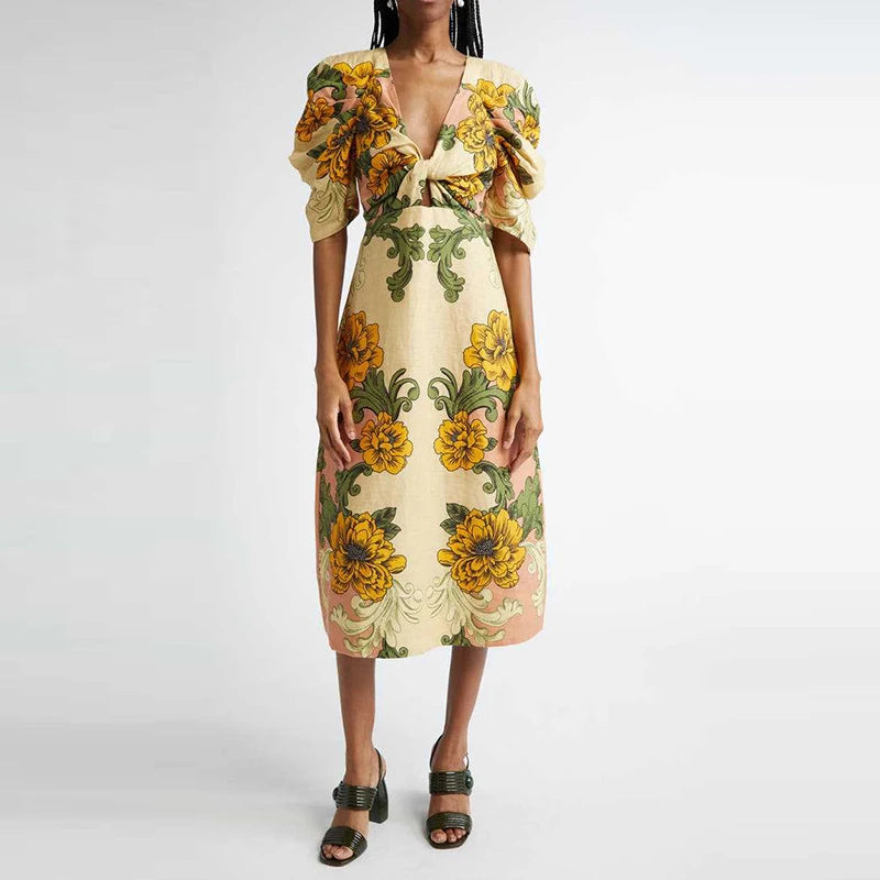 Woman wearing a floral dress with yellow and green flowers on a white background