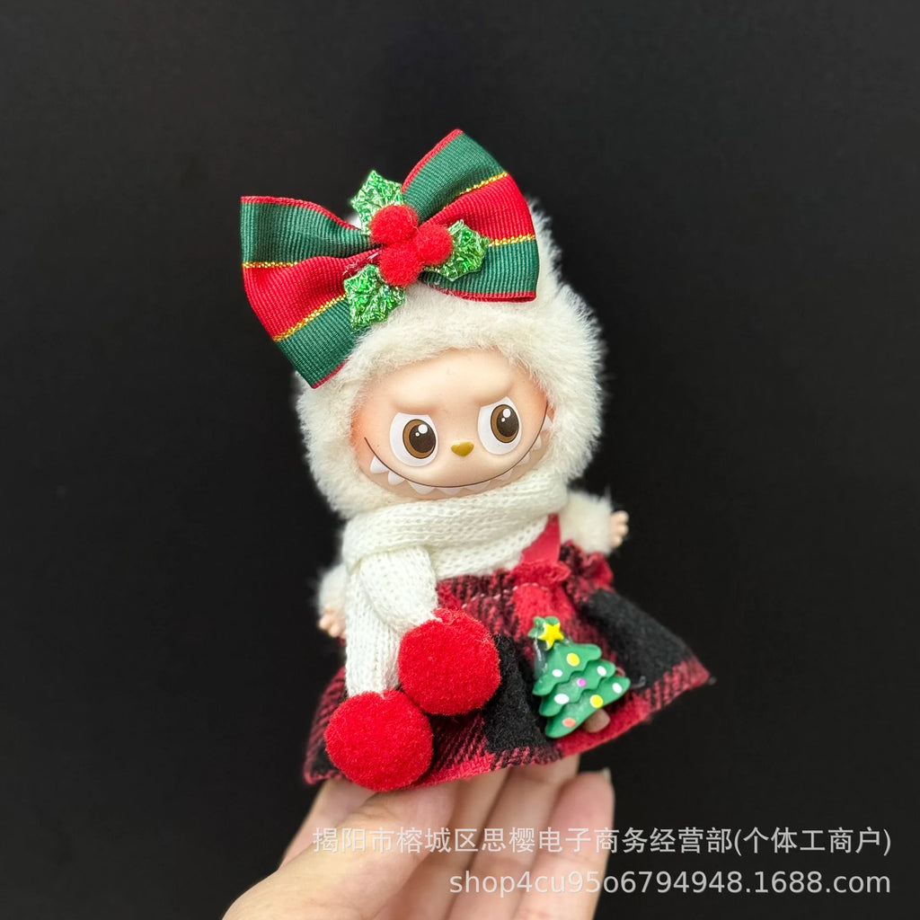 Small plush toy with a large red bow on a black background