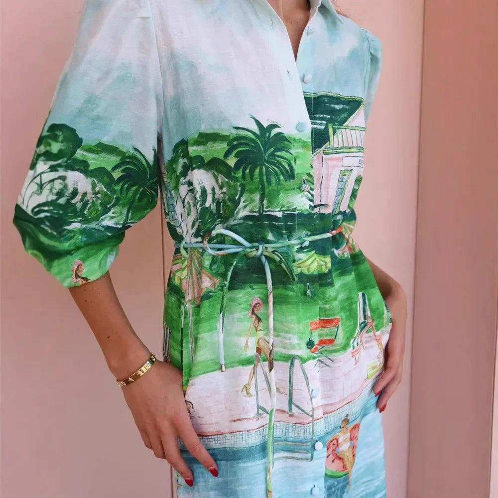 Person wearing a colorful dress with a tropical print on a pink background