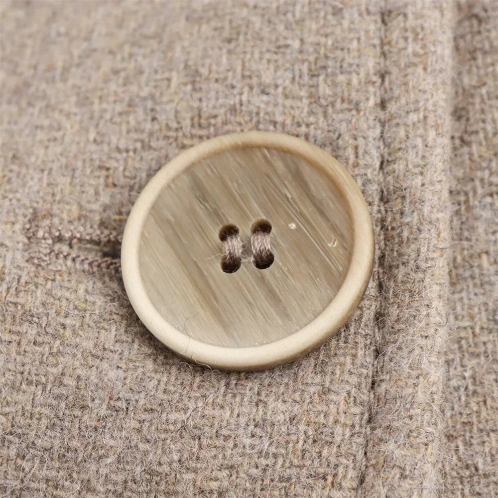 Round wooden button on a textured fabric background