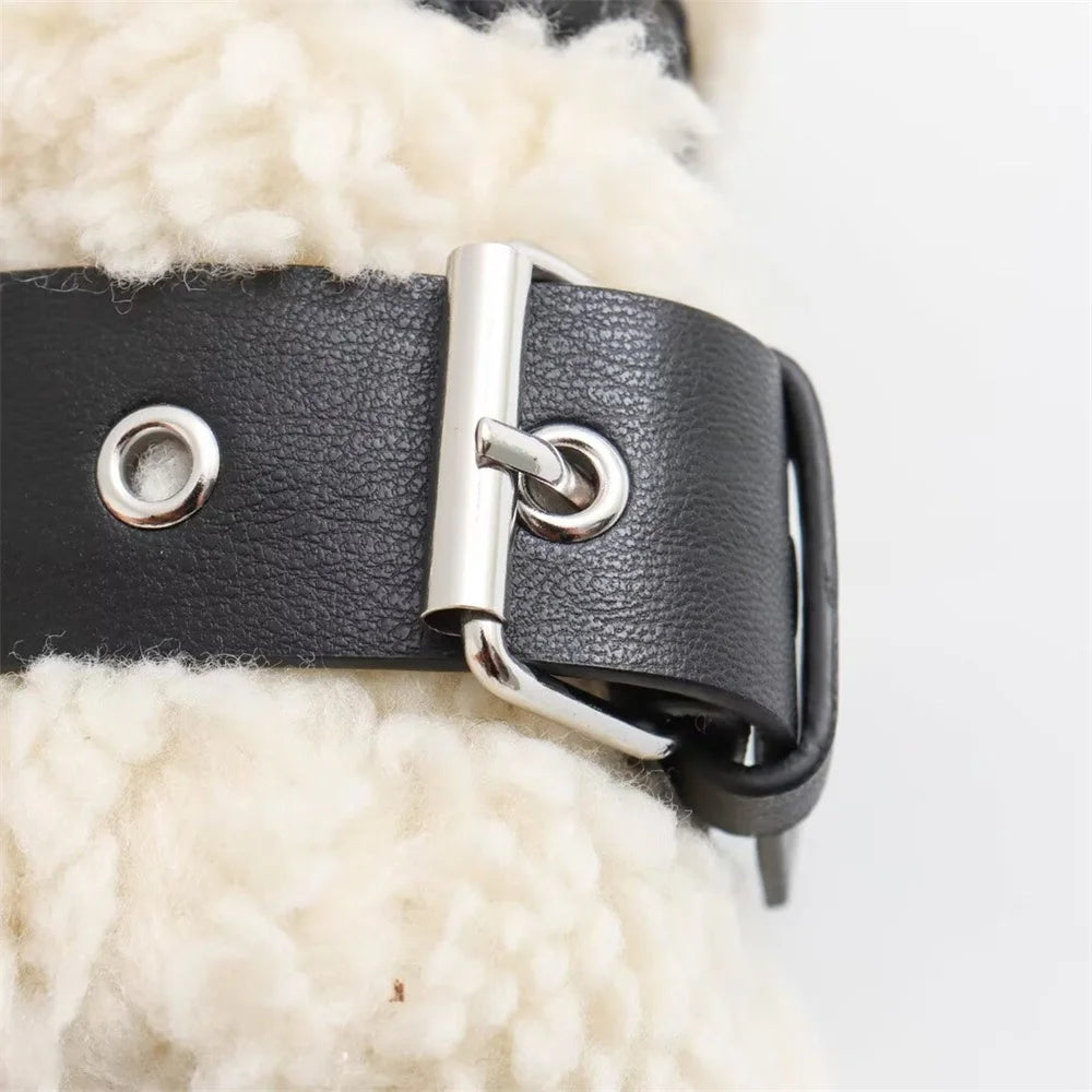 Close-up of a black leather belt with a silver buckle on a white background