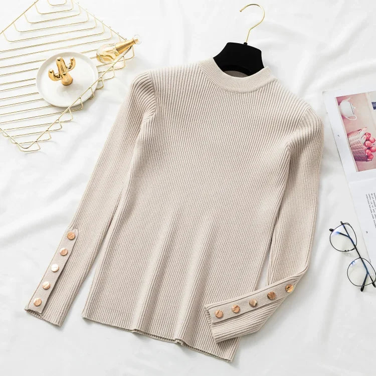 Beige ribbed sweater with button details on a white surface