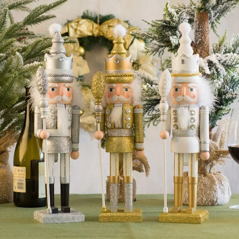 Three decorative nutcrackers in gold, silver, and white standing on a table with a festive background.