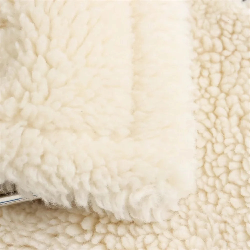 Close-up of textured beige fabric with a metal handle.