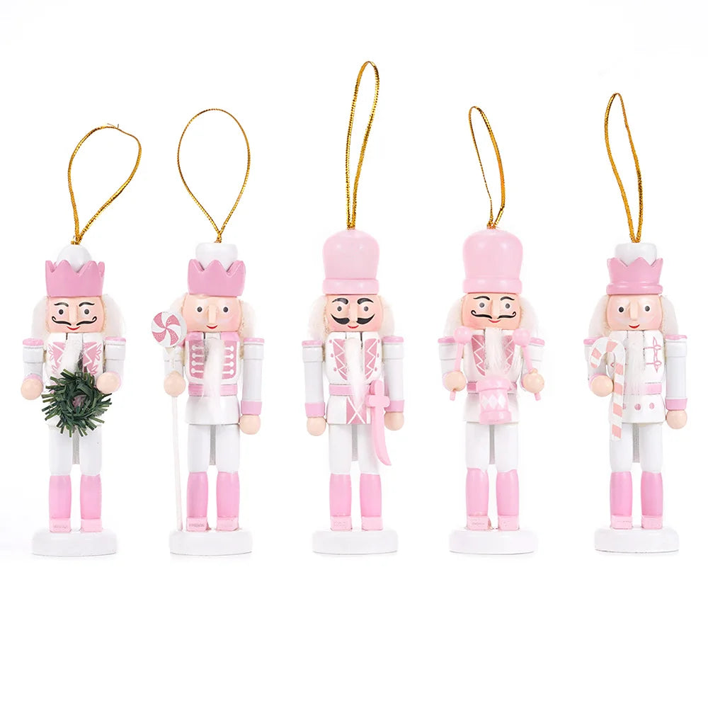 Set of five pink-themed nutcracker ornaments on a white background