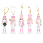 Set of five pink-themed nutcracker ornaments on a white background