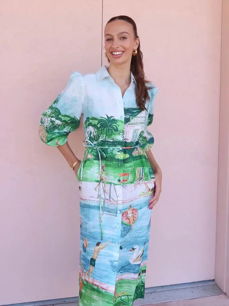Woman wearing a colorful dress with a scenic print against a plain background