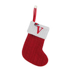 Red Christmas stocking with white cuff and embroidered letter 'V' on a white background
