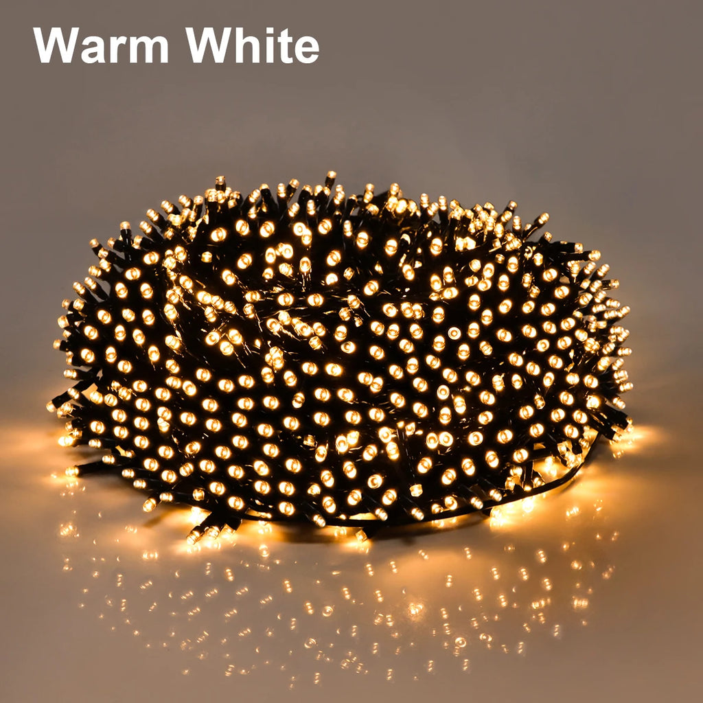Coiled string of warm white lights on a dark background