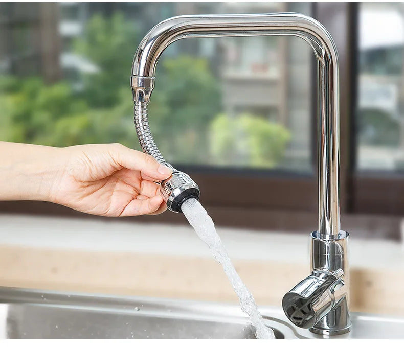Person using a kitchen faucet with a flexible hose to wash dishes.