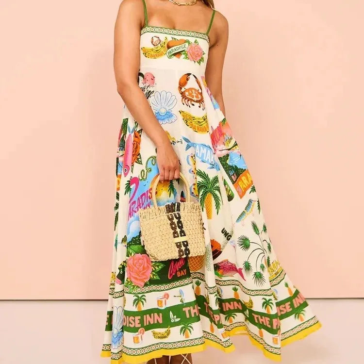 Person wearing a colorful dress with a pattern of palm trees, flowers, and text on a pink background.