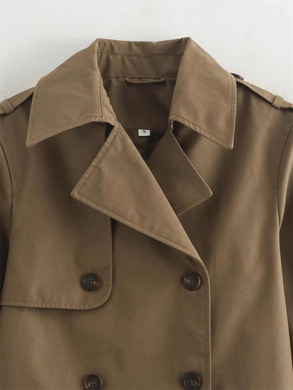 Brown trench coat with collar and buttons on a white background